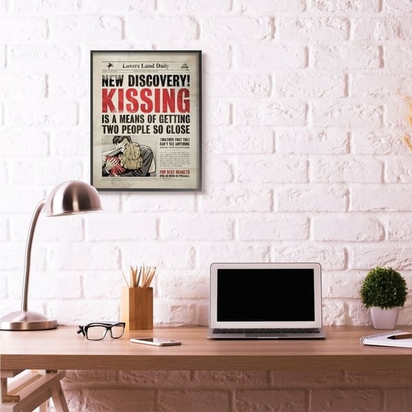 Stupell Industries Kissing Newspaper Wall Art in Black Frame