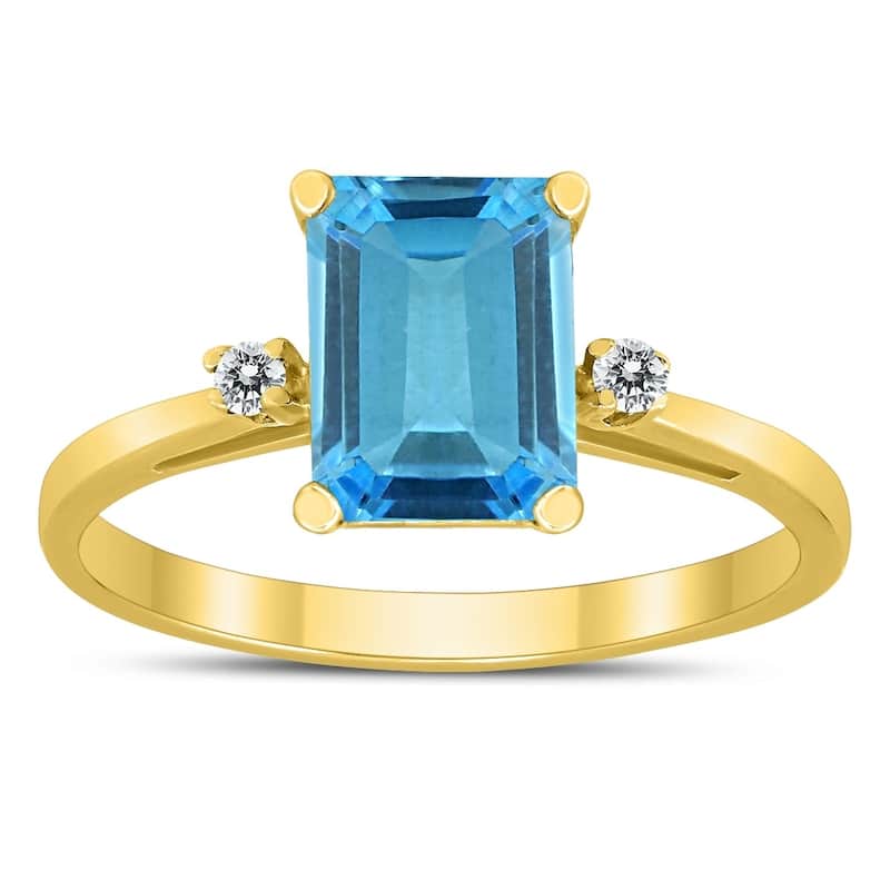 Emerald Cut 8X6MM Blue Topaz and Diamond Three Stone Ring in 10K Yellow Gold