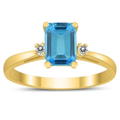 Emerald Cut 7X5MM Blue Topaz and Diamond Three Stone Ring in 10K Yellow Gold
