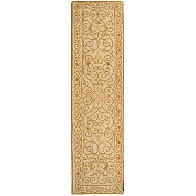 Hand hooked Iron Gate Ivory/ Gold Wool Runner (26 X 8) (IvoryPattern GeometricMeasures 0.375 inch thickTip We recommend the use of a non skid pad to keep the rug in place on smooth surfaces.All rug sizes are approximate. Due to the difference of monitor