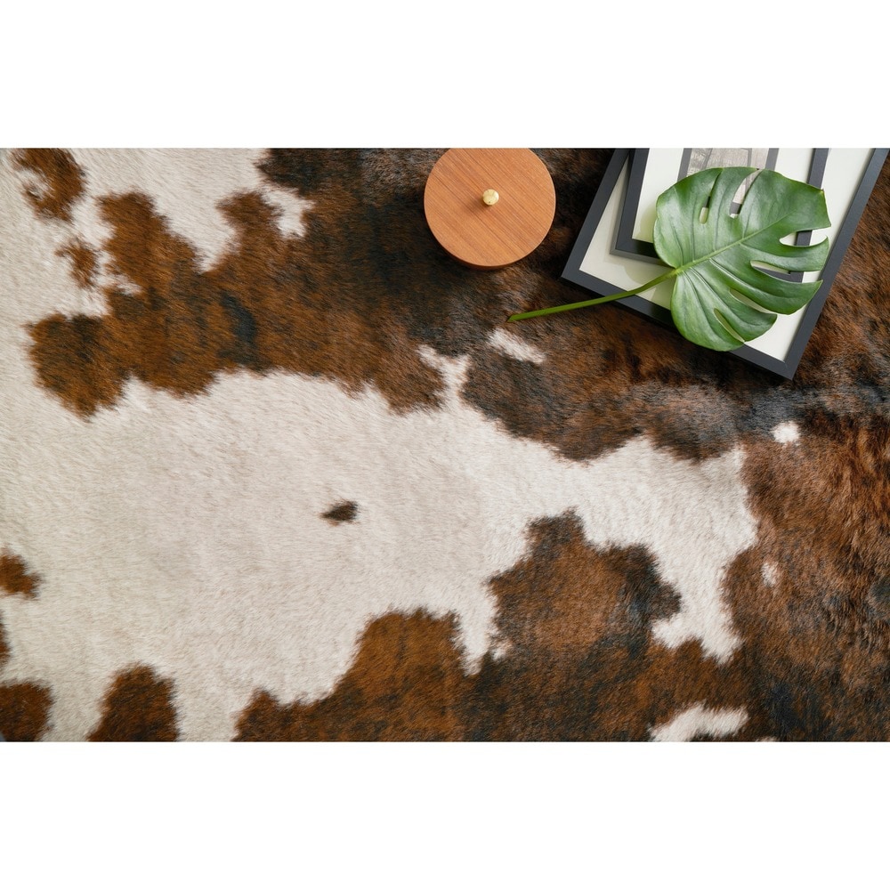 HomeRoots 5' x 8' Modern Faux Cowhide Fabric Area Rug in Brown