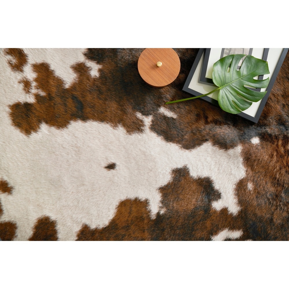 HomeRoots 5' x 8' Modern Faux Cowhide Fabric Area Rug in Brown/White