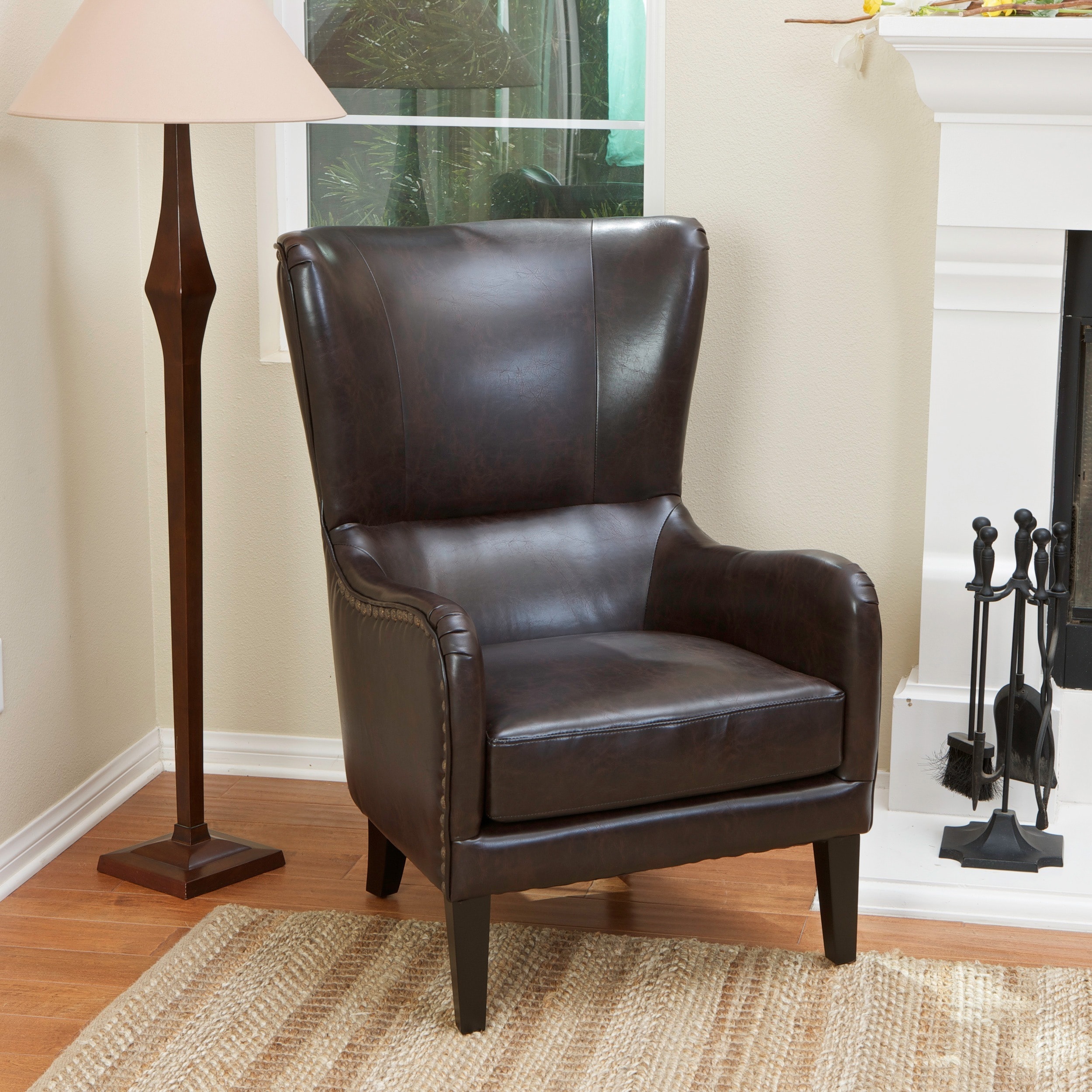 Christopher Knight Home Lorenzo Bonded Leather Studded Club Chair (BrownSome assembly requiredSturdy constructionNeutral color will match any decorSoftly padded arms, back, and seatStudded accentsEspresso stained hardwood legsDimensions 41.3 inches high 