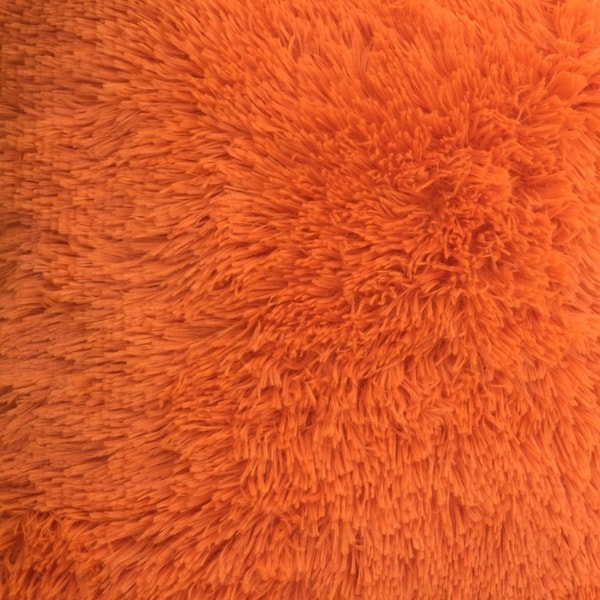 orange furry pillow