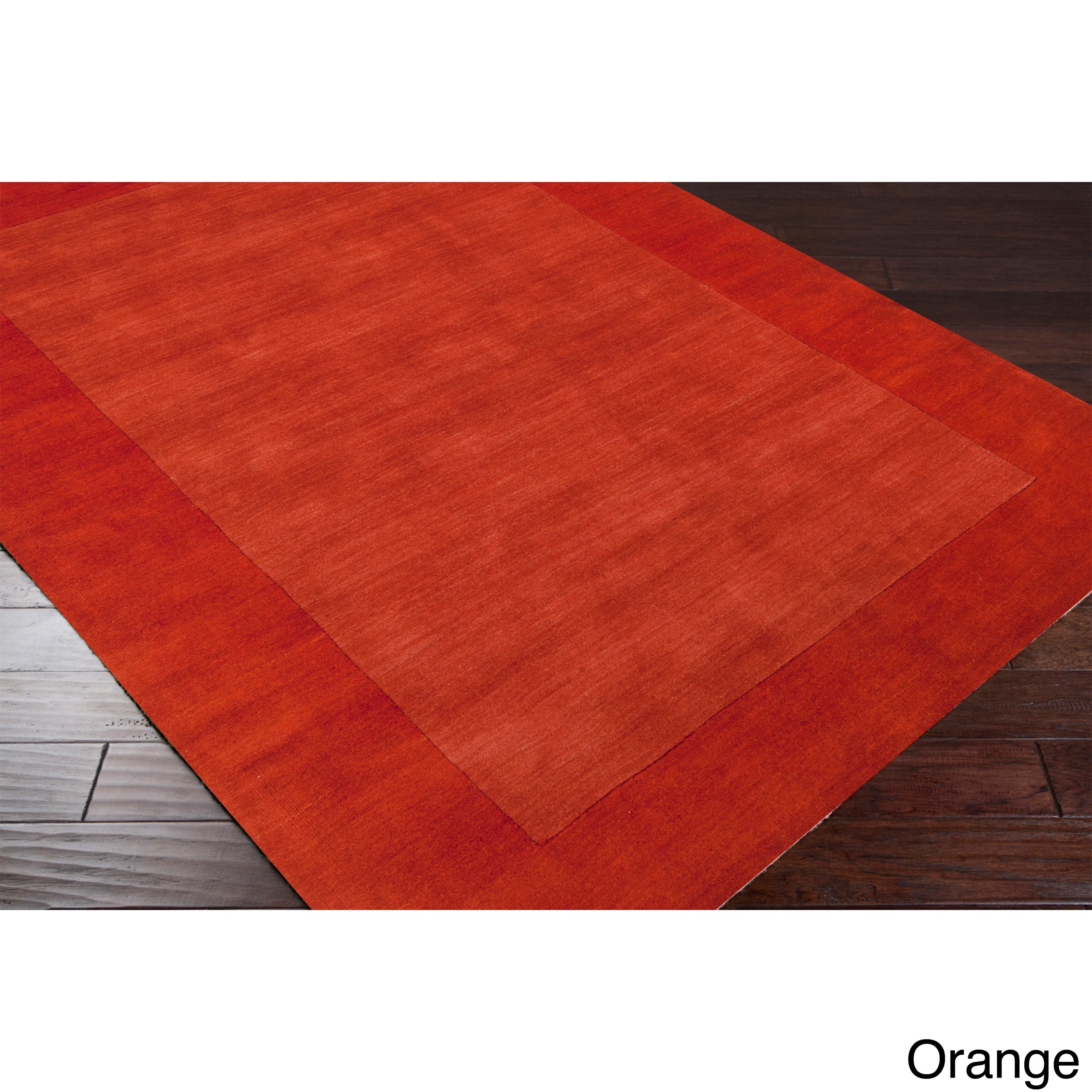 Hand loomed Risor Solid Bordered Wool Area Rug (76 X 96)