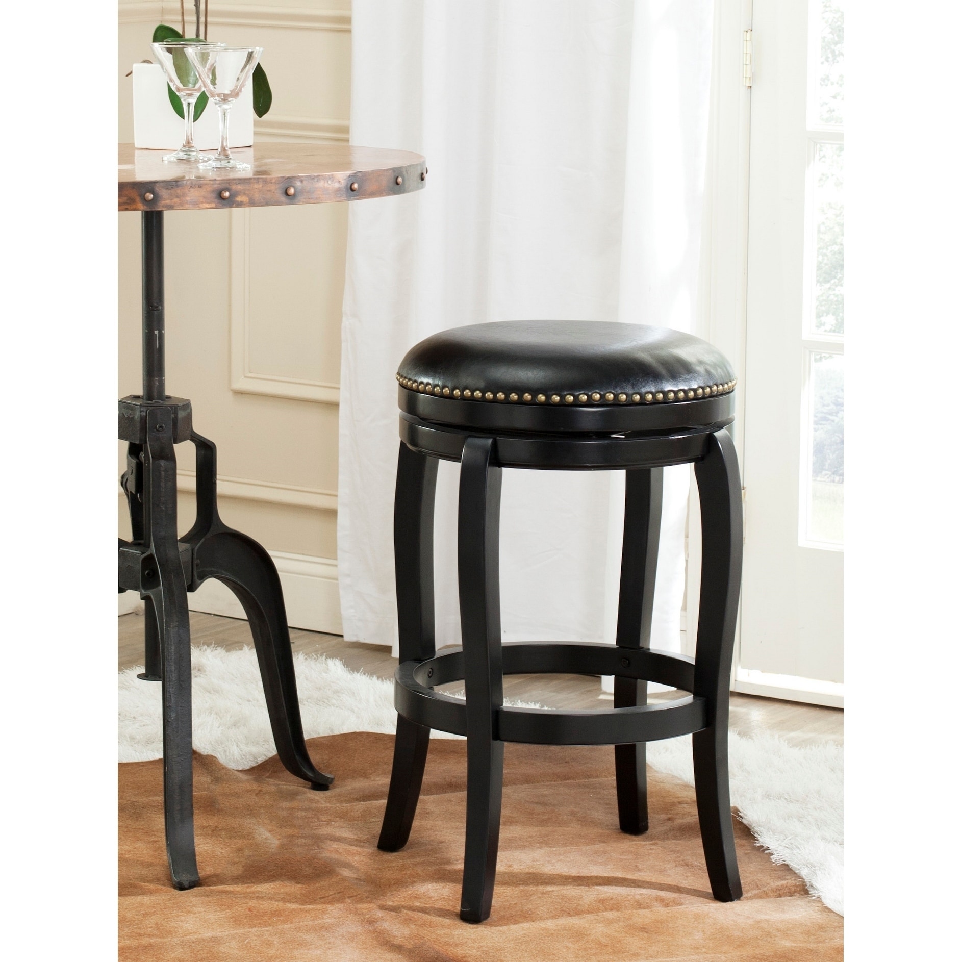 Safavieh Nuncio Black/ Black Seat Bar Stool (Black/ Black SeatIncludes One (1) stoolMaterials Rubberwood, MDF and PU fabricFinish BlackSeat dimensions 17.75 inches width and 18 inches depthSeat height 29 inchesDimensions 29 inches high x 21 inches w