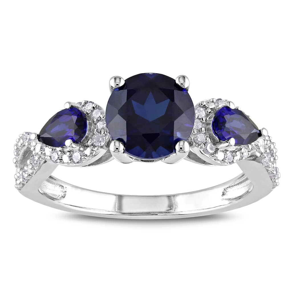 Miadora Sterling Silver Created Sapphire and 1/6ct TDW Diamond 3-Stone Crossover Ring
