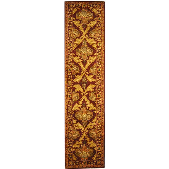 Handmade Kerman Wine/ Gold Wool Runner (23 X 8) (RedPattern OrientalMeasures 0.625 inch thickTip We recommend the use of a non skid pad to keep the rug in place on smooth surfaces.All rug sizes are approximate. Due to the difference of monitor colors, s