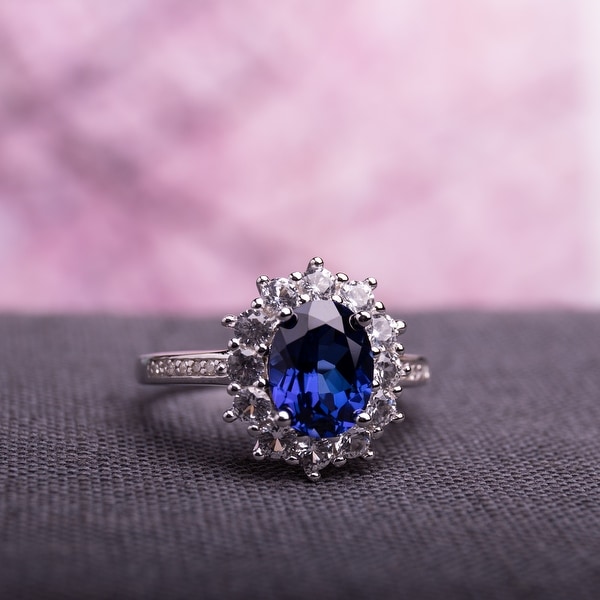 4ct TGW Created Blue and White Sapphire Diamond Halo Ring in Sterling Silver by Miadora. Opens flyout.