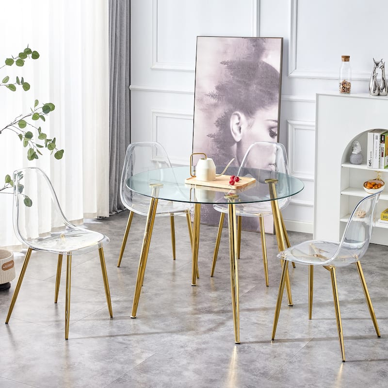 A glass tabletop with a diameter of 40 inches and a modern minimalist circular dining table with gold plated metal legs