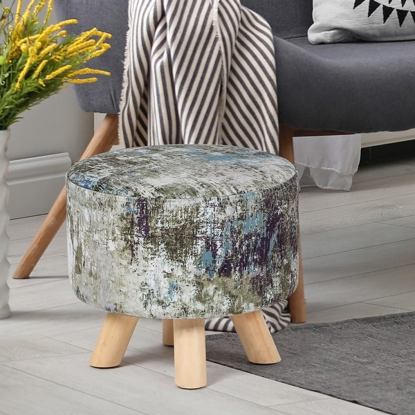 Small round low foot stool upholstered upholstered cushion material on 4 feet of wood.