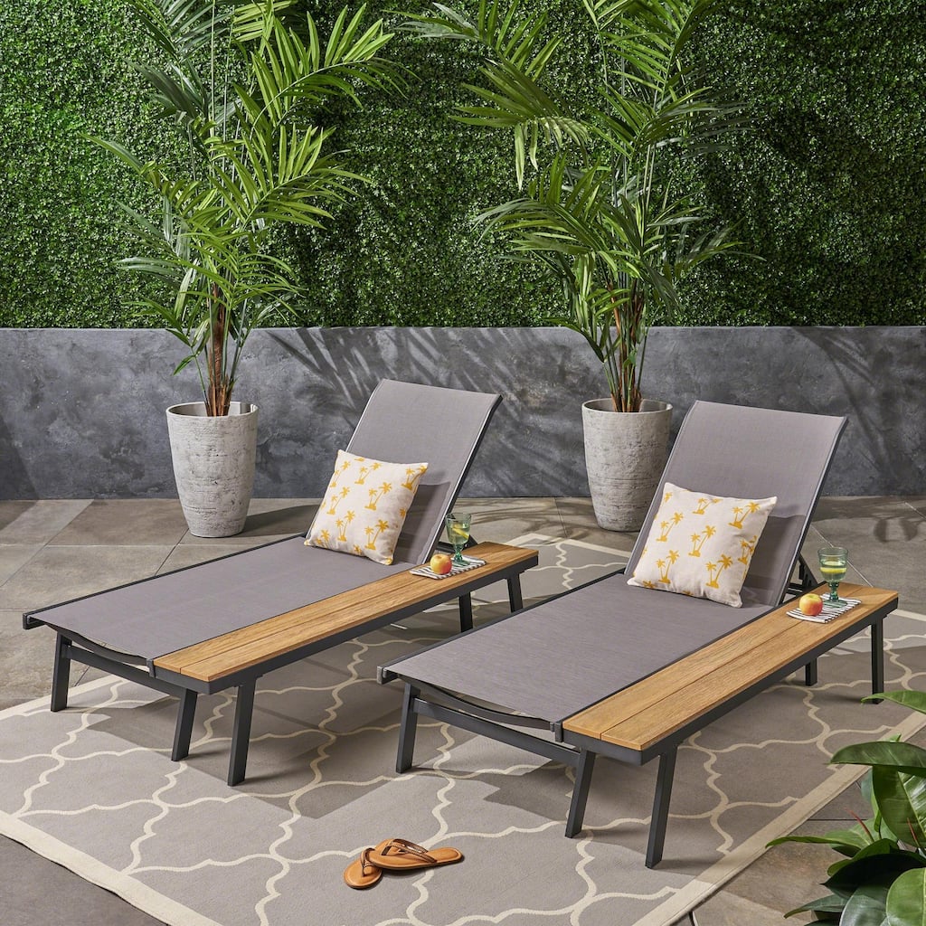 Outdoor chaise lounge with mesh seating with wooden side table