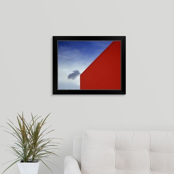 "A shadowed cloud floating through blue sky over the red corner of James John School." Black Framed Print