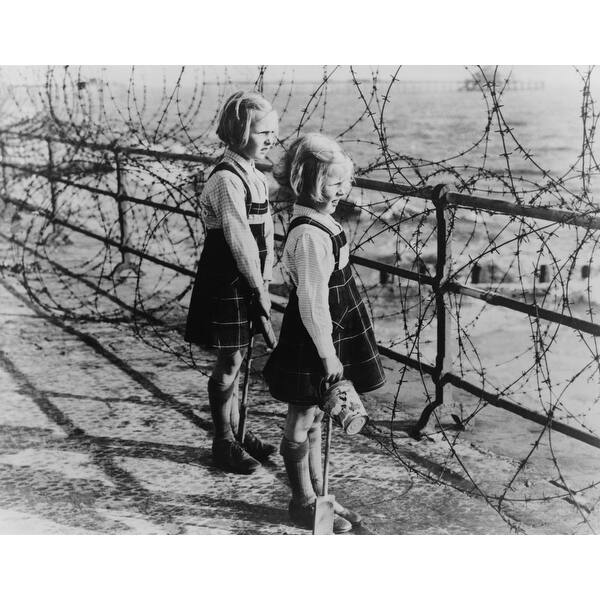 Two Girls On The South Coast Of England Look Out To The Beach Through A Barbed Wire Fence In 1940 Across The English Channel His Overstock 24348309 The idea of a winter date night outfit can feel dated—but here are six ideas to make you feel excited about dressing up for a night out. two girls on the south coast of england look out to the beach through a barbed wire fence in 1940 across the english channel his
