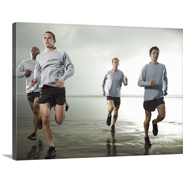 "Four men running on beach by ocean" Canvas Wall Art