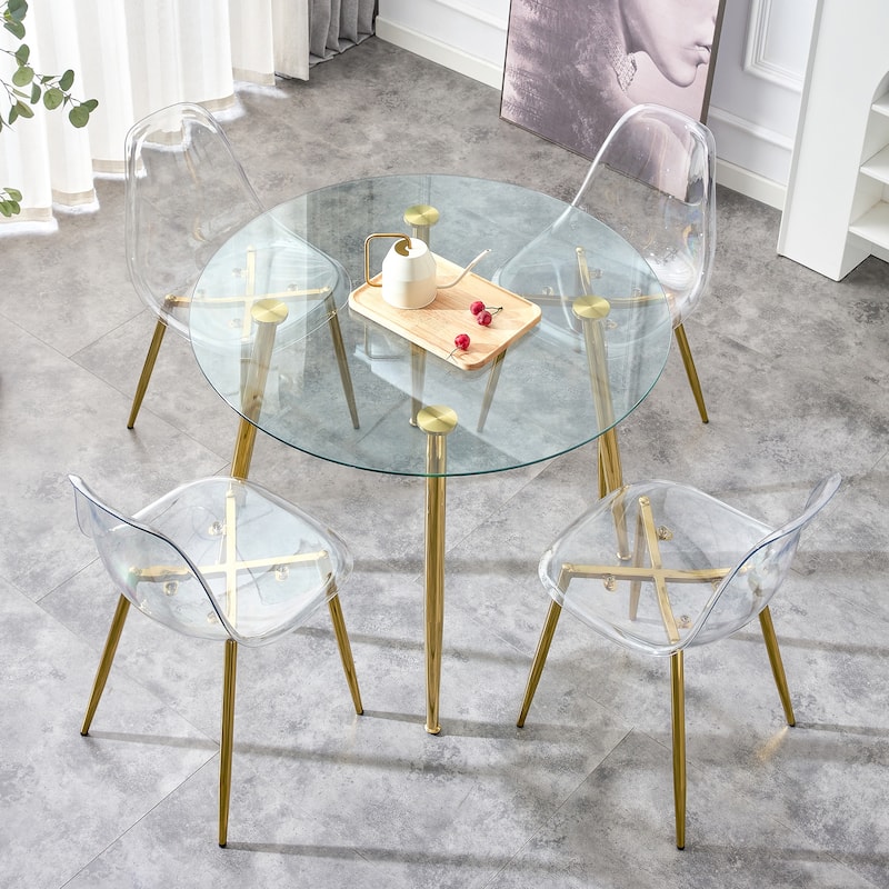 A glass tabletop with a diameter of 40 inches and a modern minimalist circular dining table with gold plated metal legs