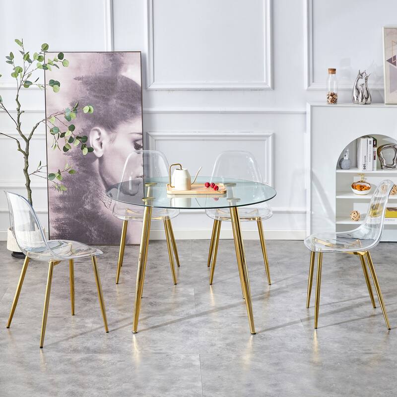 A glass tabletop with a diameter of 40 inches and a modern minimalist circular dining table with gold plated metal legs.