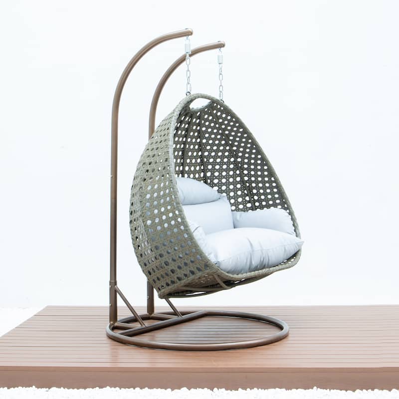 LeisureMod 2-Person Hanging Egg Swing Chair with Metal Stand - Handcrafted Beige Wicker, Patio Hammock Lounger with Cushions