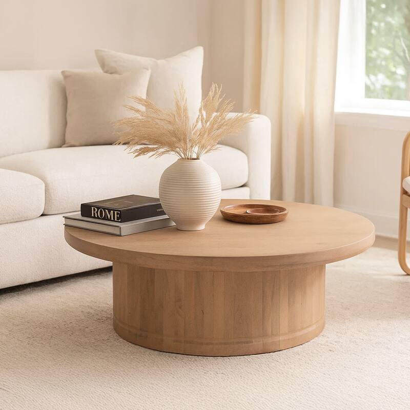 Bela Coffee Table 47 Inch Round Top Handcrafted Beige Mango Wood Pedestal Base