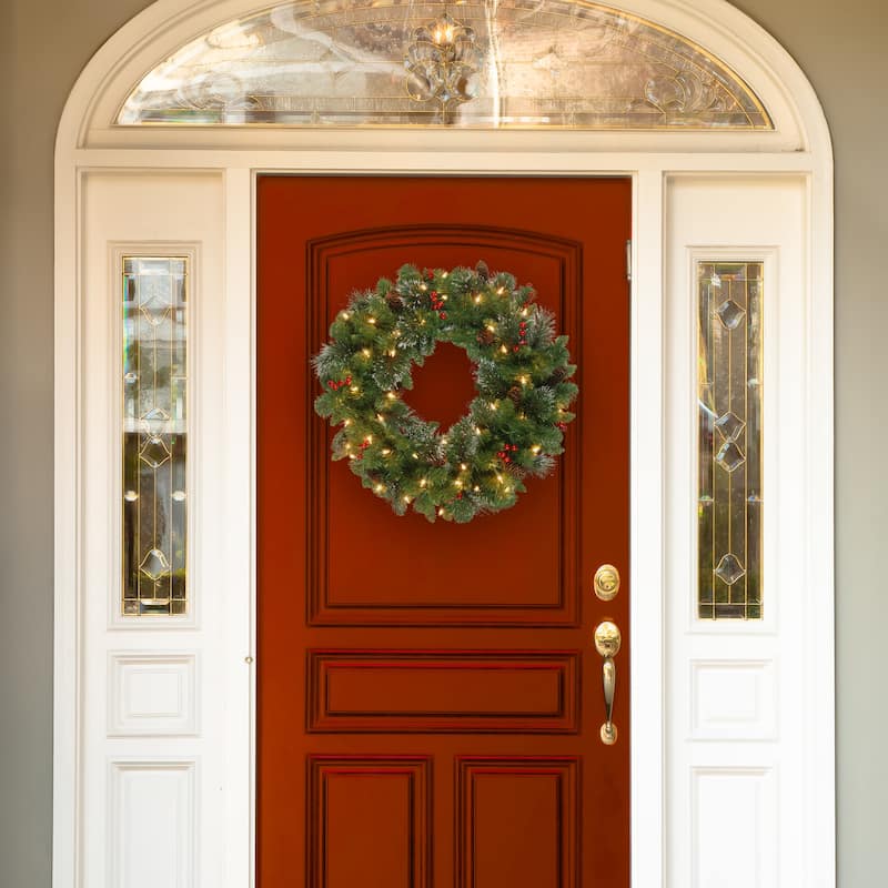 National Tree Company 24 in. Crestwood Spruce Wreath with Silver Bristle, Cones, Red Berries and Glitter with 50 Clear Lights