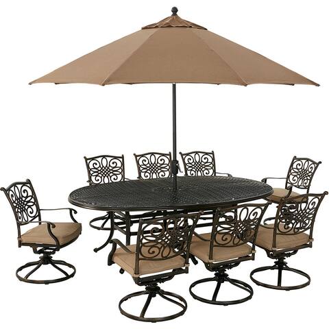 Hanover Traditions 9-Piece Dining Set in Tan with 8 Swivel Rockers, 95-in. x 60-in. Oval Cast-Top Table, Umbrella