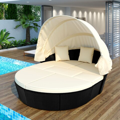 Outdoor rattan daybed with retractable canopy and washable cushions