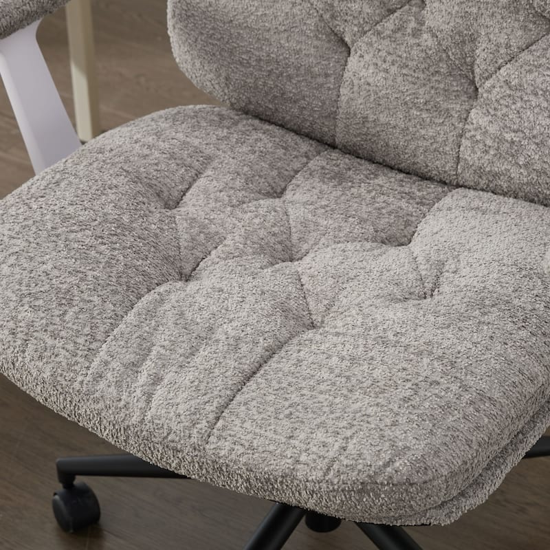 Grey Swivel Chair with Flip-Up Armrests and Crossed Legs