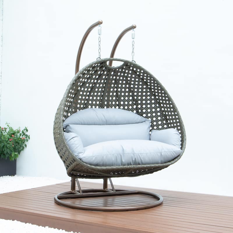 LeisureMod 2-Person Hanging Egg Swing Chair with Metal Stand - Handcrafted Beige Wicker, Patio Hammock Lounger with Cushions