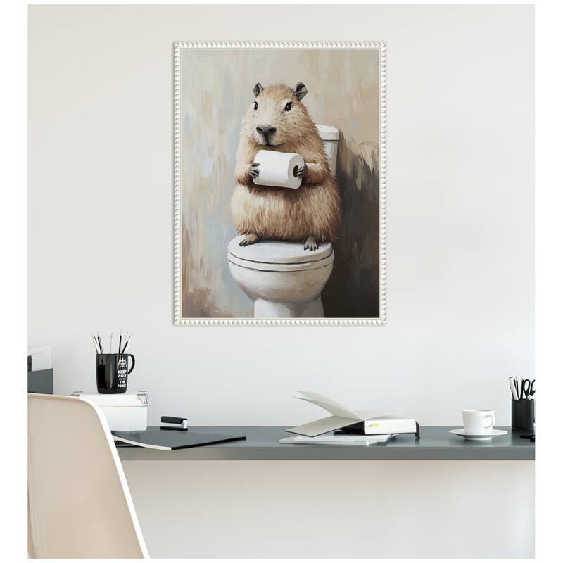 Kate and Laurel Sylvie Capybara Angled Holding Toilet Paper Roll Toilet Bathroom Art Framed Canvas by The Creative Bunch Studio