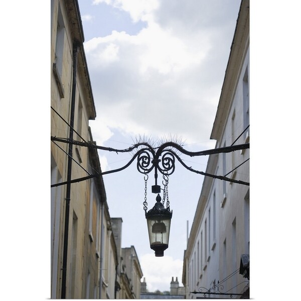 "Lamp hanging between buildings" Poster Print