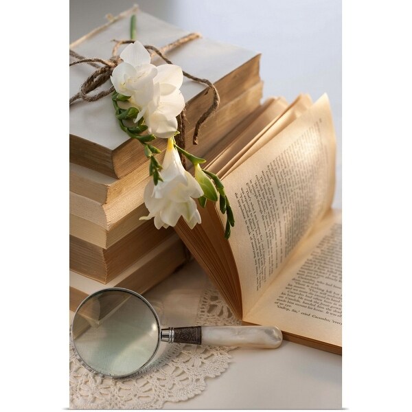 "Magnifying glass beside stack of books with flowers" Poster Print