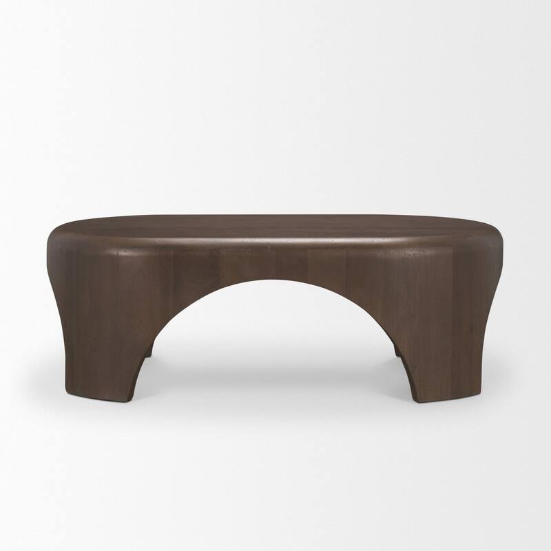 The Shima Coffee Table is a smooth, dark matte brown oval coffee table with curved edges and arched cut out legs.