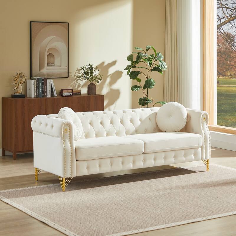 Chesterfield Sofa with Two Round Pillows, Featuring Copper Stud Detailing and Tufted Button Accents