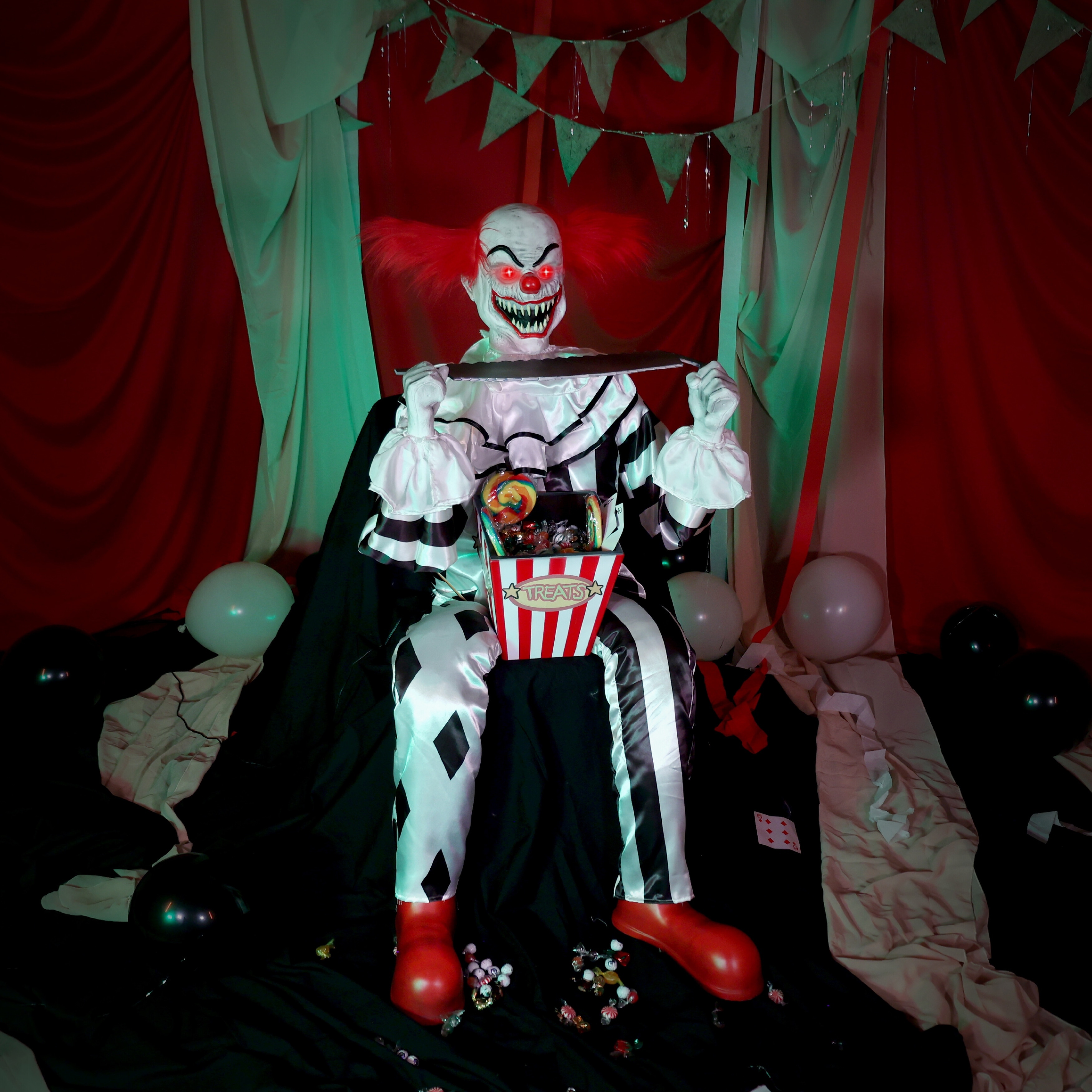 Haunted Hill Farm 4.1-Ft. Sitting Scareclown with Saw & Candy Animatronic
