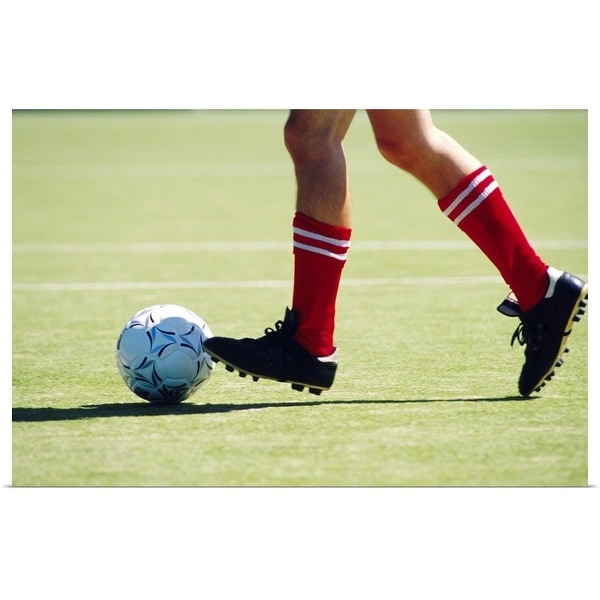 "Feet of soccer player kicking ball" Poster Print