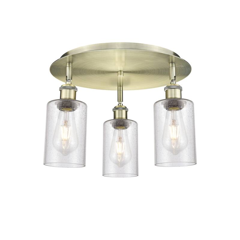 Innovations Lighting Clymer - 3 Light 16" Flush Mount - Antique Brass/Seedy