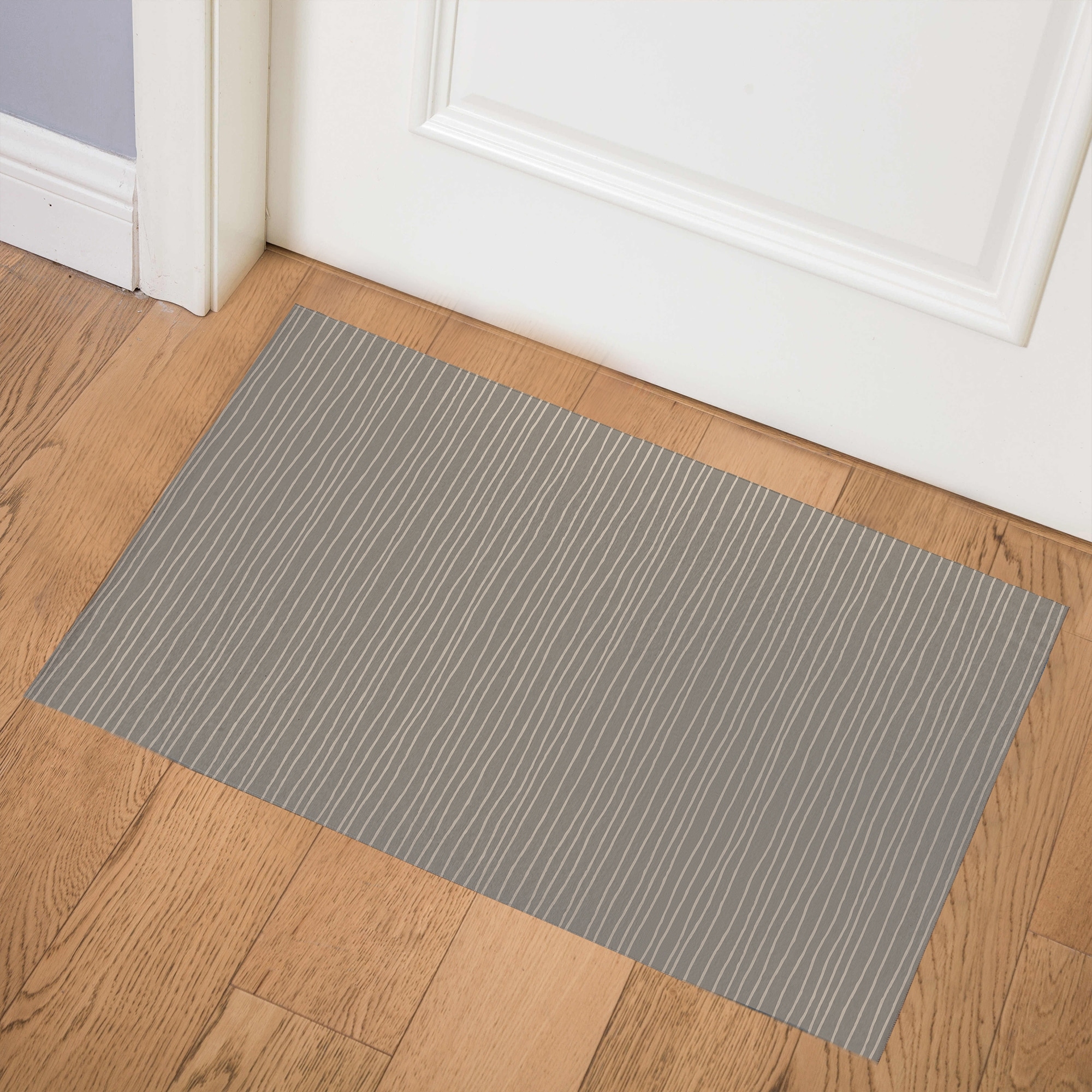 https://ak1.ostkcdn.com/images/products/is/images/direct/18695b0159e2782bb113ac5e375c18b079cbbccc/LINEAR-TAUPE-Indoor-Door-Mat-By-Kavka-Designs.jpg