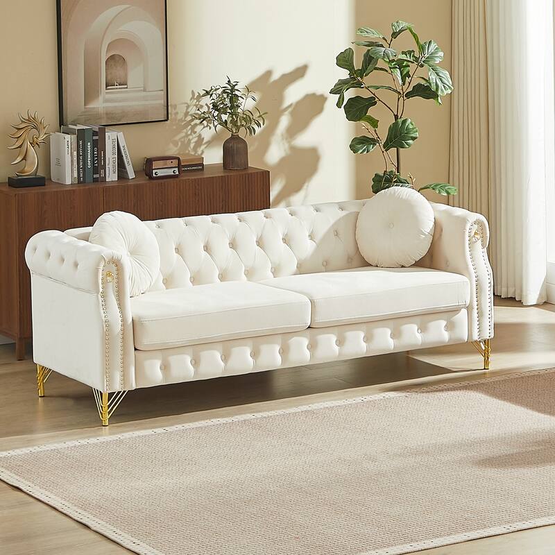 Chesterfield Sofa with Two Round Pillows, Featuring Copper Stud Detailing and Tufted Button Accents