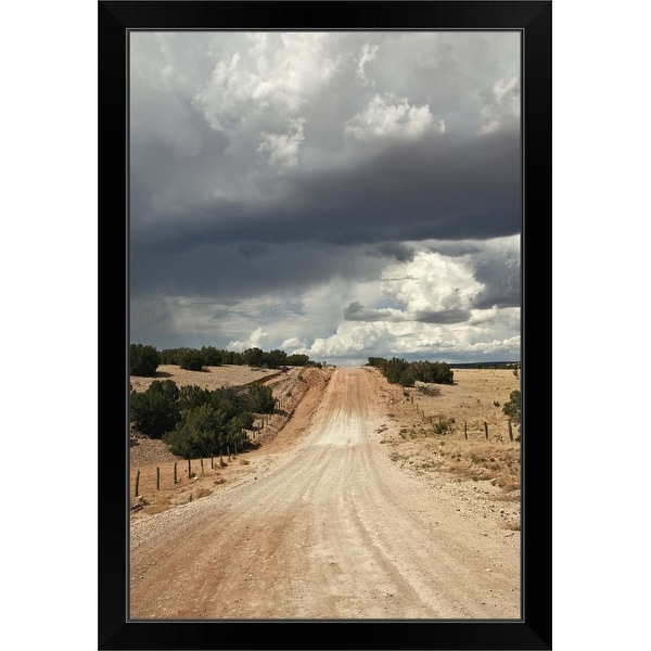 "Looking down a dirt country road in New Mexico with rain clouds in sky" Black Framed Print