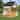 Kids Outdoor Wooden Playhouse, Cottage Play House with Door, Windows, Bench & Blackboard, Multi-Functional Play Toy for Ages 3-8