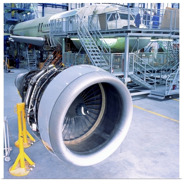 "close-up of an aircrafts engine turbine kept in a hanger for assembly" Poster Print