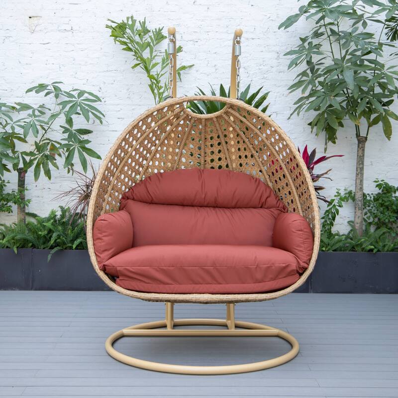 LeisureMod Mendoza 2-Person Hanging Egg Swing Chair - Handcrafted Light Brown Wicker, Patio Hammock Lounger with Cushions - 53"