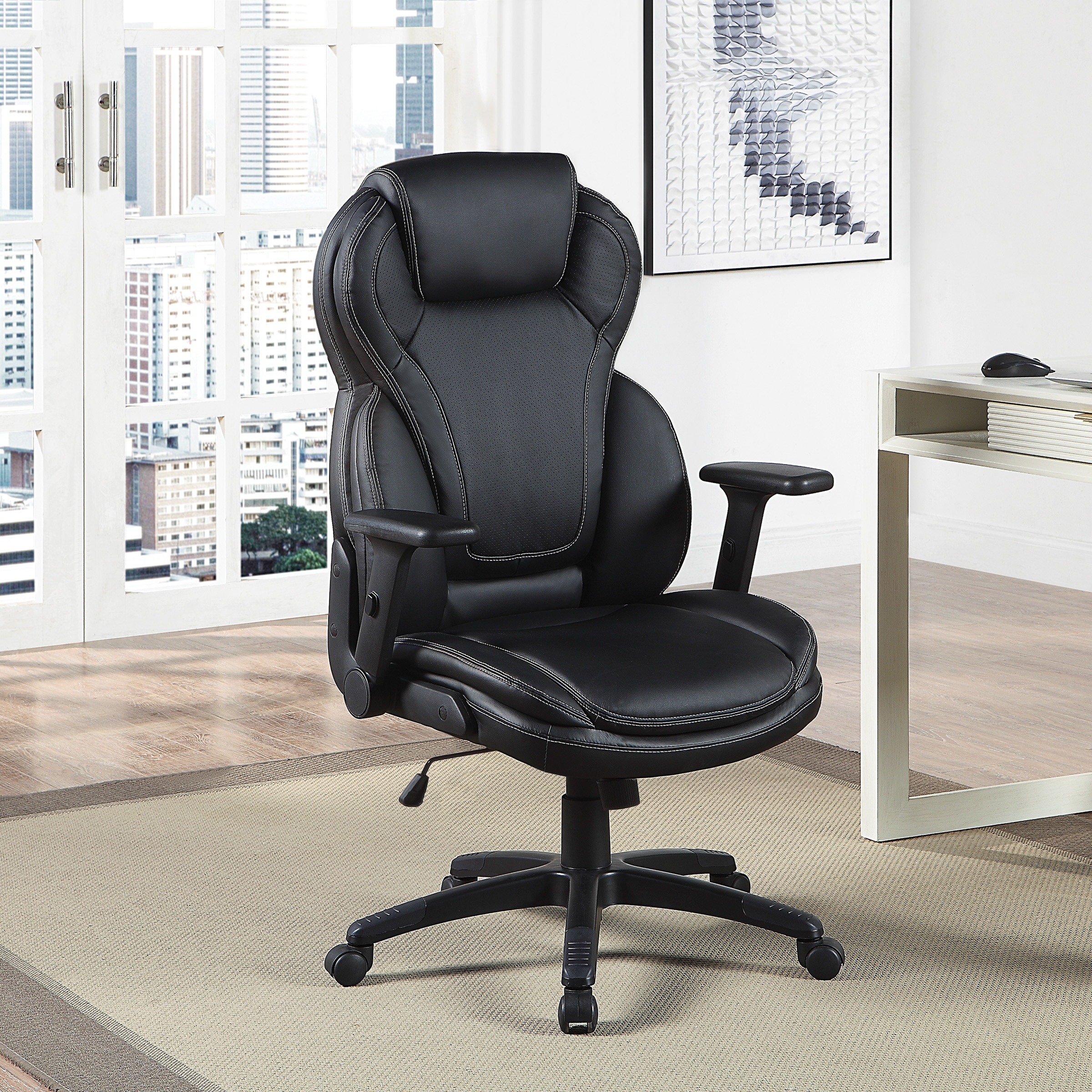 Ergonomic office chair in black leather-look with high back, plush cushion, and adjustable armrests in an office-like room.
