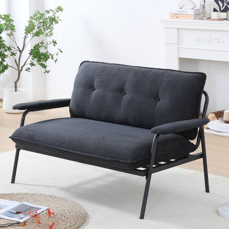 The 53-inch black sofa offers a spacious layout in the small apartment