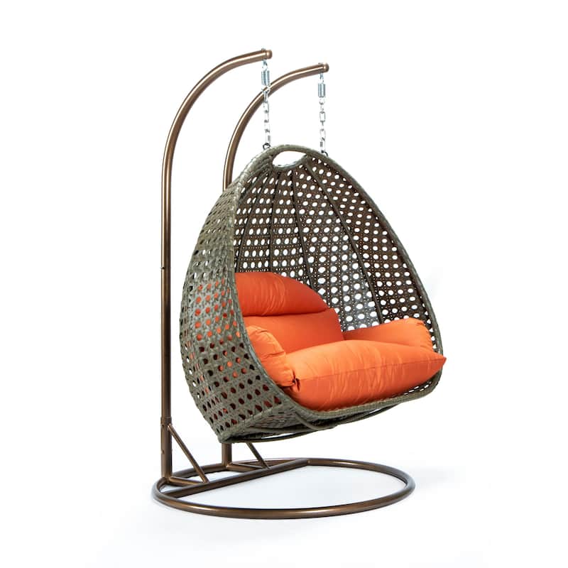 LeisureMod 2-Person Hanging Egg Swing Chair with Metal Stand - Handcrafted Beige Wicker, Patio Hammock Lounger with Cushions