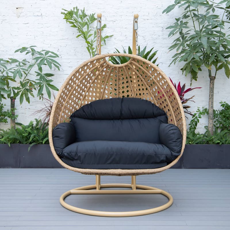 LeisureMod Mendoza 2-Person Hanging Egg Swing Chair - Handcrafted Light Brown Wicker, Patio Hammock Lounger with Cushions - 53"
