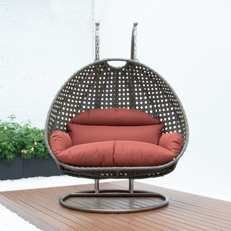 LeisureMod 2-Person Hanging Egg Swing Chair with Metal Stand - Handcrafted Beige Wicker, Patio Hammock Lounger with Cushions