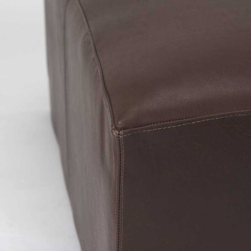 A leather ottoman with versatile style and function.