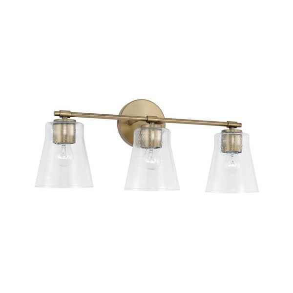 slide 2 of 12, Baker 3-light Bath/ Vanity Fixture w/ Clear Seeded Glass Aged Brass