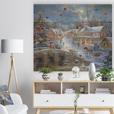 Designart 'Christmas Paradise with church snow and open sleigh' Print on Natural Pine Wood - Orange